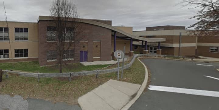 Westhill-Stamford&#x27;s longtime swimming and diving coach Rick Lewis returned to his team Tuesday after a school district investigation found that he an assistant had not contributed to poor pool conditions that sickened several teen athletes.