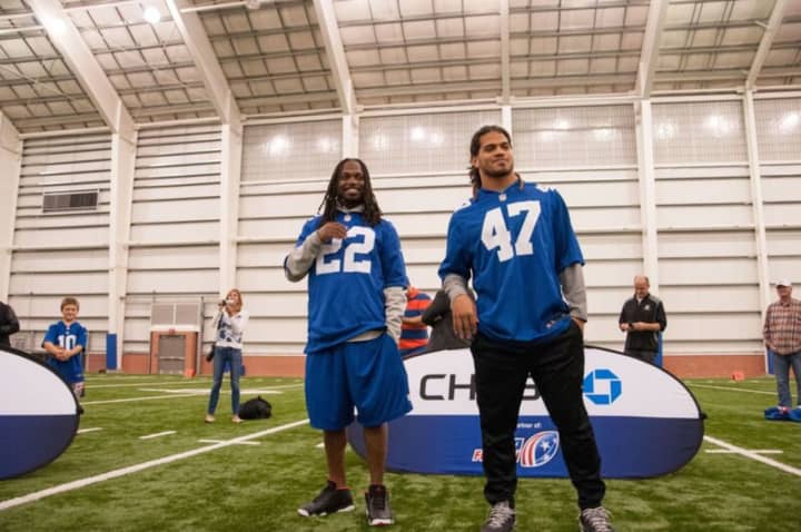 Giants linebacker Uani ‘Unga and safety Brandon Meriweather. The Giants will have their annual Toys for Tots drive Dec. 20.