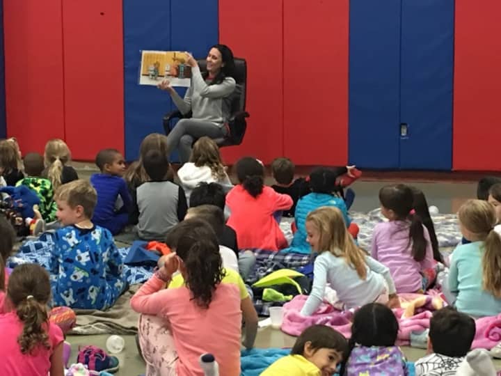 Children&#x27;s book author Christina Geist reads &quot;Buddy&#x27;s Bedtime Battery&quot; to children at the William B. Ward Elementary School&#x27;s recent read-a-thon pajama party in New Rochelle.