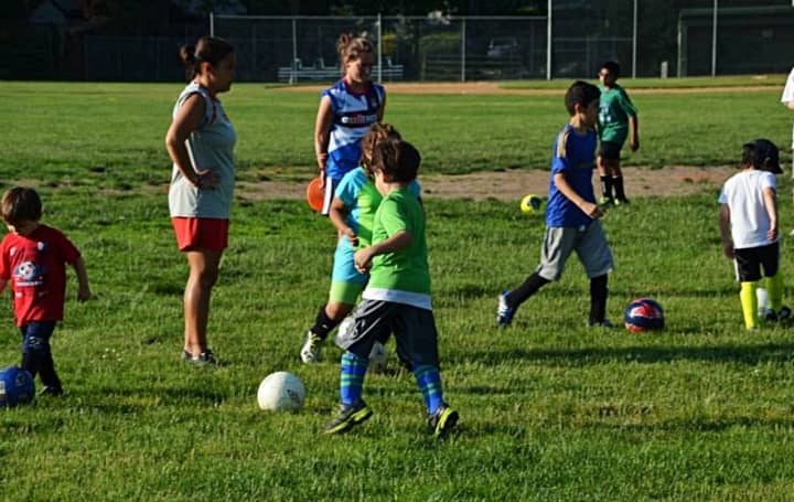 Younger kids have at it during a 2014 AYSO soccer clinic.