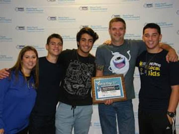 New Rochelle High School students Jack Dubicki, Nick Fazio and Chris Hough with Nintendo representative Kevin Pritchard and Meredith Buono from Maria Fareri Children&#x27;s Hospital.