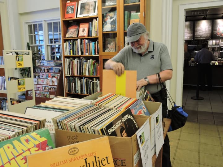A customer peruses boxes of vintage vinyl at the Friends Book Shop at the Ferguson Library in Stamford. A 50 percent off sale on all gardening and cook books runs through Aug. 6.