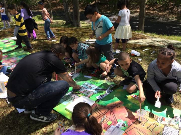 Woodside Elementary School students in Peekskill collaborate on a mural with artists. The artwork will be open for public viewing June 4.