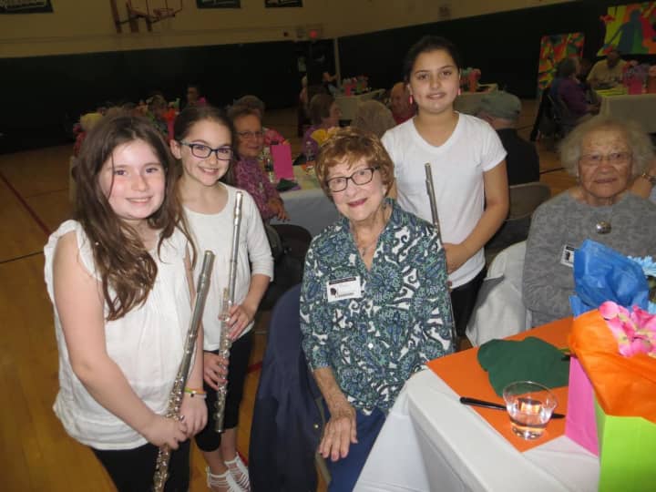 June Offerman (center) and Eleanor Kwap (right) are greeted by students Alexandra Schajer, Angelina Curtin and Sara Maloney at the recent Brewster School District luncheon.