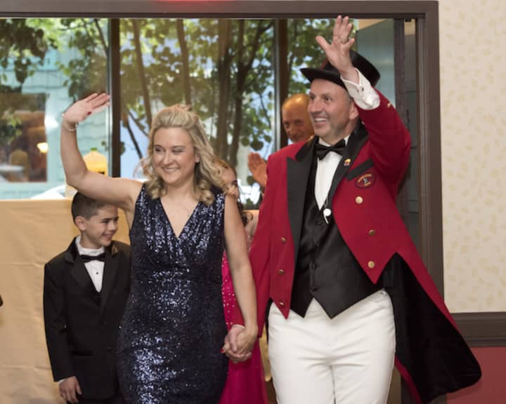 Jason Julian, the Barnum Festival Ringmaster, waves to the crowd along with his wife, Tammy.