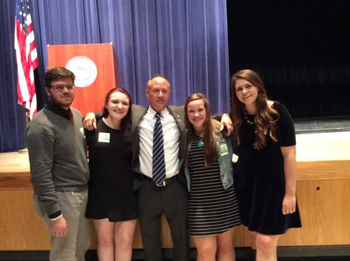 Mark Barden, father of a victim of the Sandy Hook shooting, embraces student leaders at Danbury High School who introduced the Say Something program at their school last year. Barden is one of the founders of the Sandy Hook Promise.