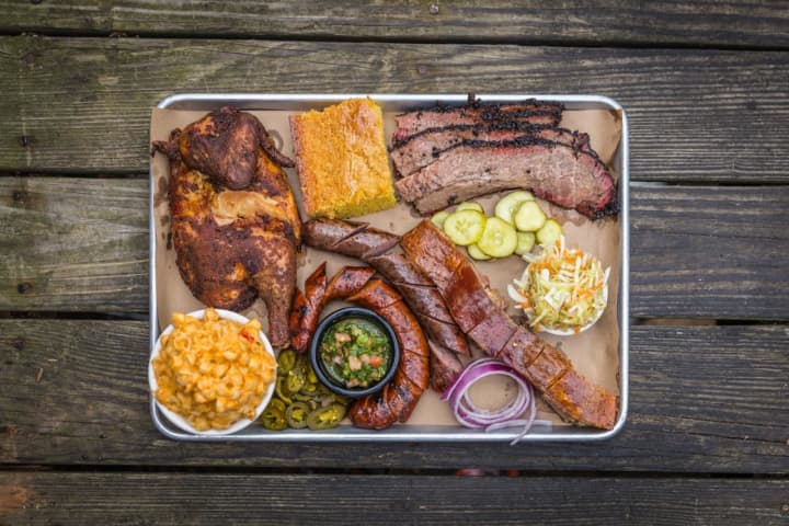 A plate of barbecued entrees is shown at Hoodoo Brown BBQ in Ridgefield where platters of food can be shared family-style.