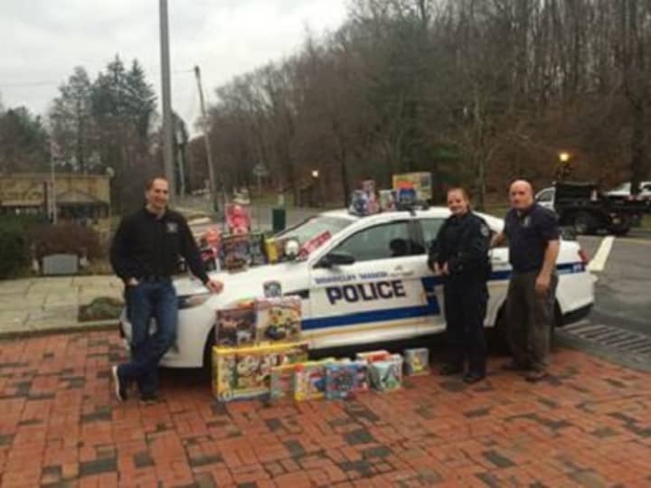 Officers Galbraith, DiMiglio and Wynn from the Briarcliff Police Department display some of the items that were collected for the annual toy and coat drives.
