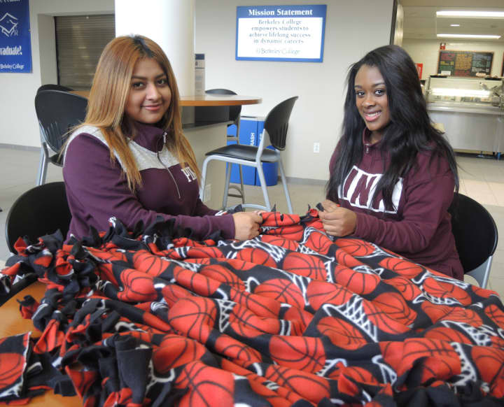 Berkeley College students Eneyda de Dios of Paterson and Zoe Patterson of Elmwood Park work on blankets for Project Linus.