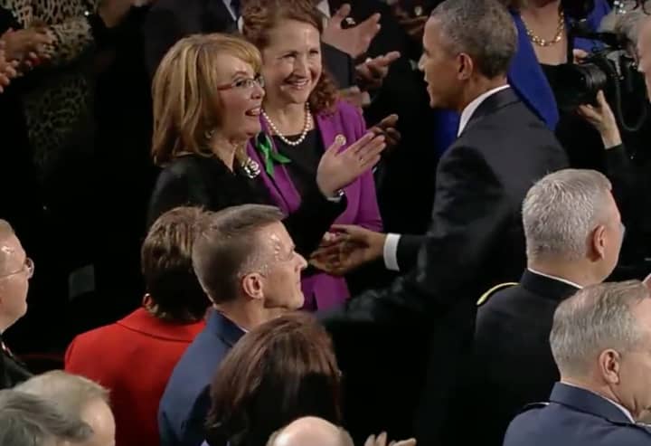 Gabrielle Giffords reaches out to President Barack Obama before the State of the Union Address begins Tuesday night. Giffords, a former Congresswoman and gun violence victim, is sitting with U.S. Rep. Elizabeth Esty (D-Conn., 5th District).