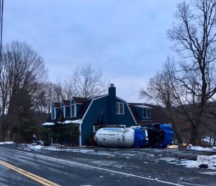A Monroe truck driver was cited after the tanker truck full of propane he was driving went off the road and hit a house in Bethany