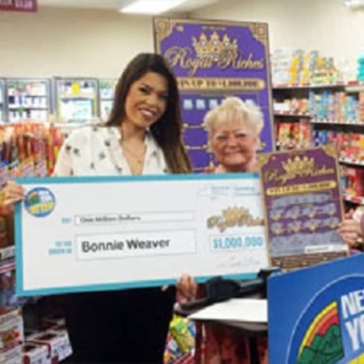 Hopewell Junction resident Bonnie Weaver, right, and an unidentified woman hold a facsimile of her winnings from a $1 million &quot;Royal Riches&quot; scratch-off card.