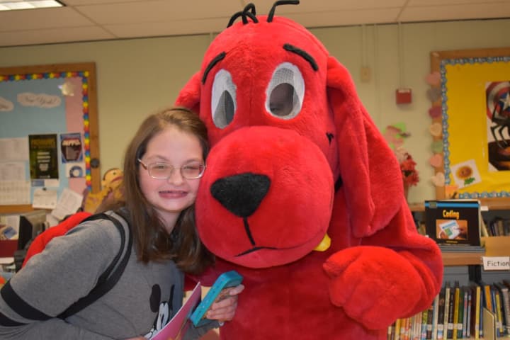 A student poses with Clifford at the BOCES Book Fair.