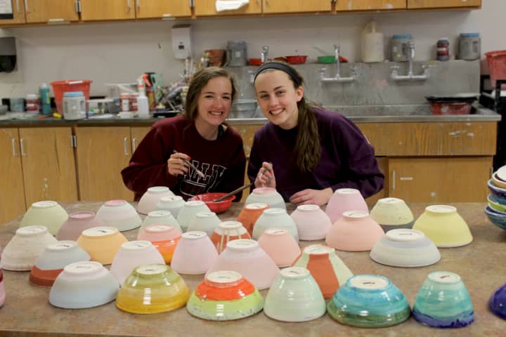 Erin Flanagan and Jenna Szabo prepare ceramic bowls to be sold at the PVHS arts festival, to benefit the Ramapo Bergen Animal Refuge.