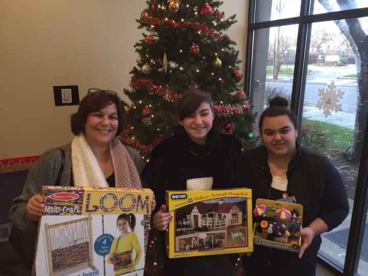 Trumbull resident Cindy Anelante, her daughter, Cassandra Anelante and Rosario Terron, lead bilingual advocate at The Center for Family Justice, with toys Cassandra collected.