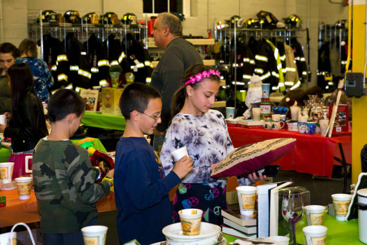 Besnik, Anthony and Julianna Sejfijaj gather at a table for the Penny Social, which was held by the Croton Falls Fire Department&#x27;s Ladies Auxiliary.