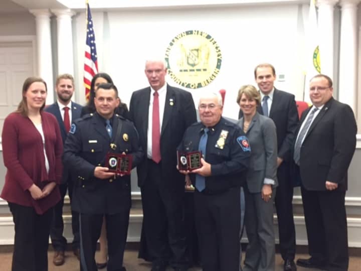 Special Chief Nicholas Magarelli (left) and Auxiliary Chief Kenneth Pfeiffer receive awards from Mayor John Cosgrove (center) and Fair Lawn officials.