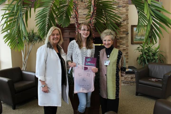 Mahopac teen Caitlin Andersen, center, shows one of the comfort bags she delivered to cancer patients to oncology nurse navigator Dianne Toscano, left, and Anita Minella, executive director of the Putnam Hospital Center Foundation.