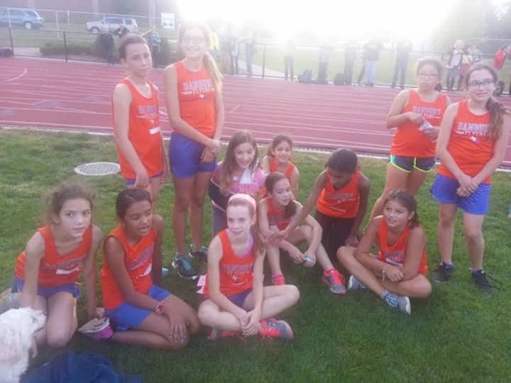 Girls on the Danbury Flyers youth cross country team take a breather after a race in Bethel. 
