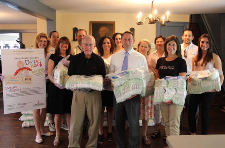 Westchester County Executive Robert Astorino, center in white shirt, and members of the Westchester County Diaper Bank celebrate one year of service to local families.