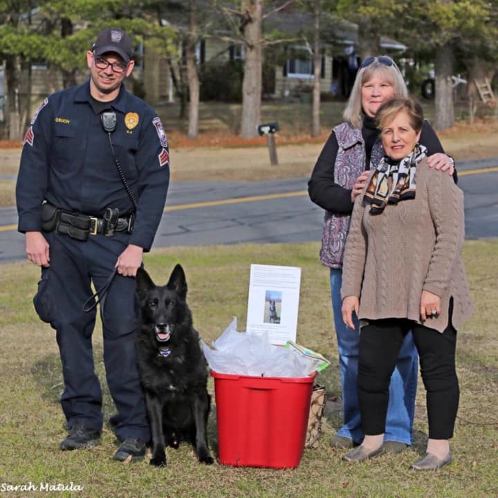 Brookfield Police K9 Bruno, Sgt. Jeff Osuch and volunteers assembled to show Bruno their appreciation for helping to find a missing girl. The volunteers brought a container of treats for Bruno.
