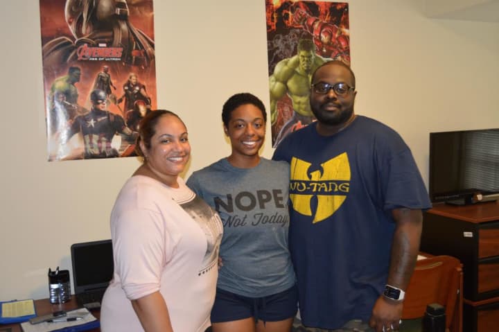 Jelexus Watkins and her parents complete the finishing touches on her dorm room at Fairfield Hall at Western Connecticut State University in Danbury, 