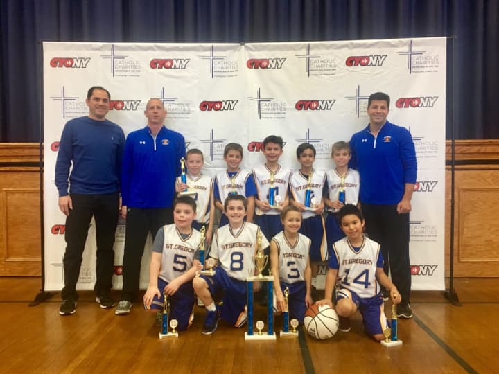 St. Gregory&#x27;s state championship basketball team with their coaches. The Harrison third-graders won the state title on Sunday after a 19-0 season.