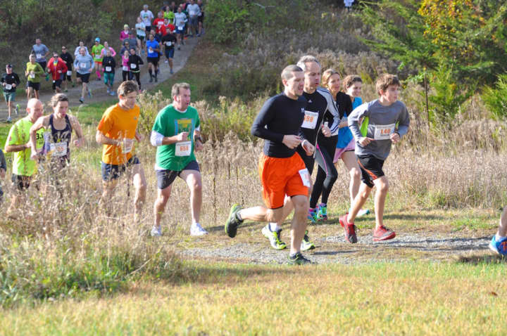 Runners head out on the 5-mile course of a previous Run the Farm race.
