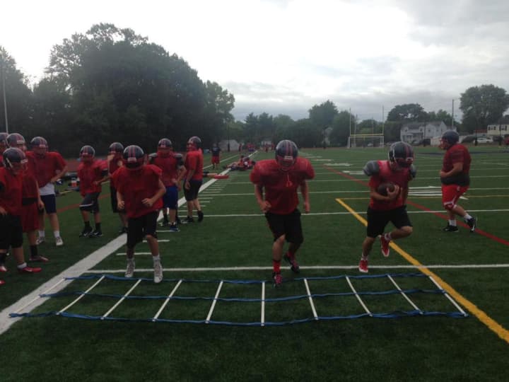 Eastchester&#x27;s football team works out during summer camp.