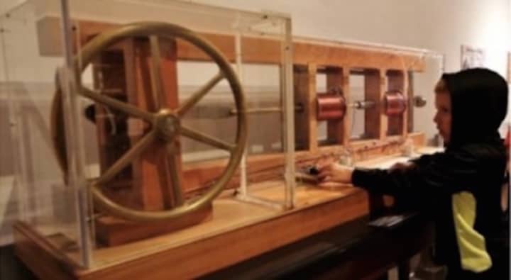 Many early electric motors were reciprocating motors, like the one shown, that moves the wheel when the coils are turned turn on and off at just the right time. View this at the new &quot;Electricity&quot; exhibit at the Bruce Museum starting May 14.