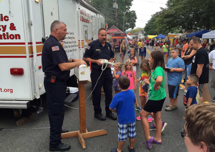 Brewster Fire Department members teach fire safety to kids on Main Street in Brewster.