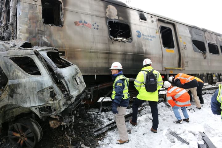 Investigators survey the vehicle involved in a Feb. 3, 2015, commuter train crash on Metro-North Railroad&#x27;s Harlem Line in Valhalla.