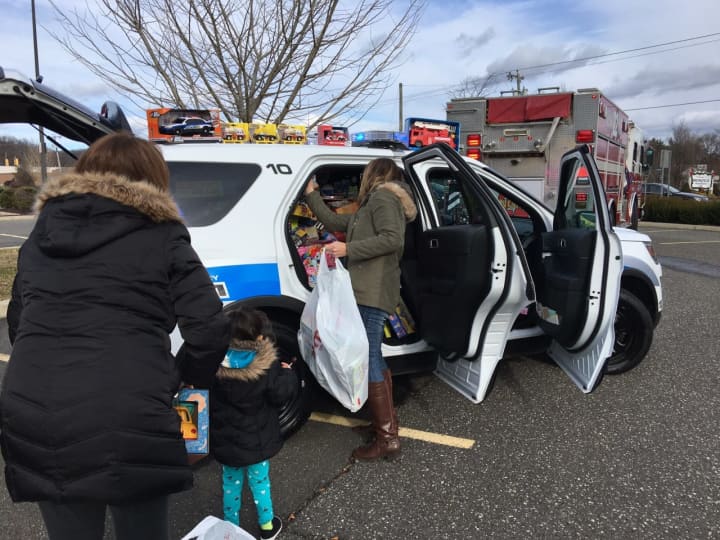 A Brookfield Police cruiser is loaded with toys for kids at Connecticut Children&#x27;s Medical Center in Hartford.