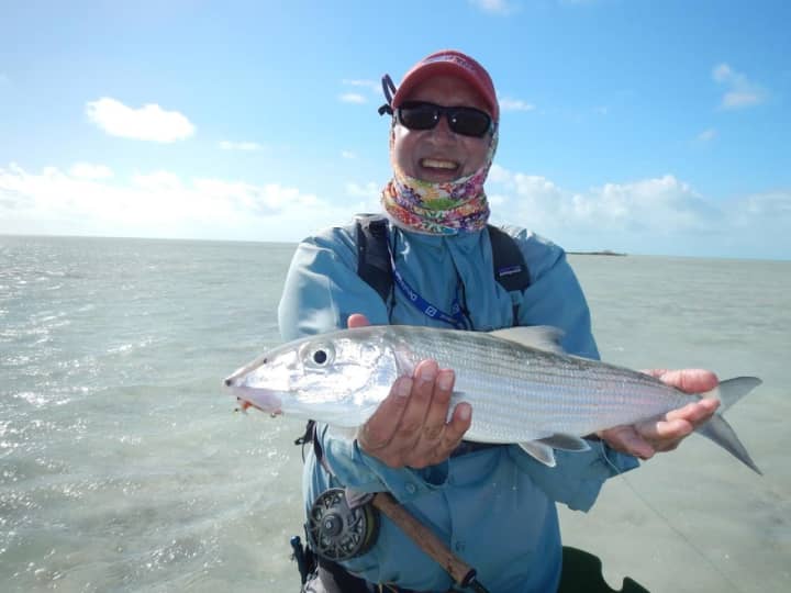 Sekhar Bahadur holds up a bonefish he caught on a recent trip to the Bahamas with staff from The Compleat Angler in Darien.