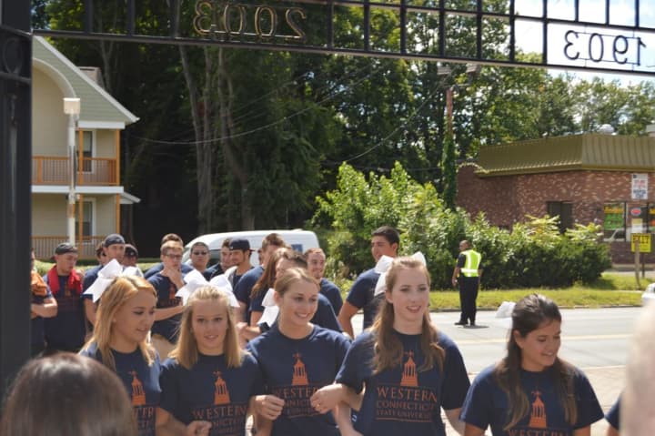 The students march through the gates as they are welcomed Friday at Western Connecticut State University in Danbury. 
