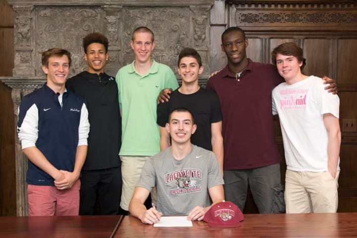 Dom Cristiano Jr. of Valhalla, N.Y., seated, signs his letter of intent to play basketball at Lafayette College. With him are GFA teammates (left to right) Henry Holzinger, Elvin Rodriguez, Pat Seegers, Evan Roteman Sunday Okeke and Bennett Close.