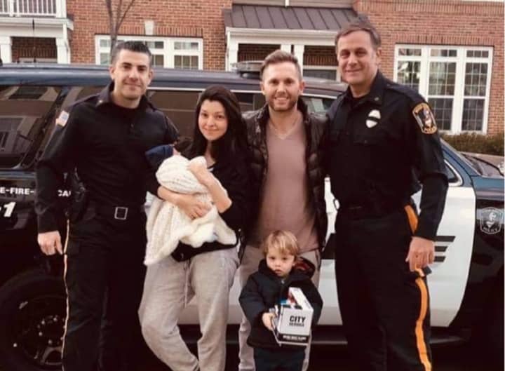 Officers Roberto Cangialosi and Michael Mueller and the Jackson family.