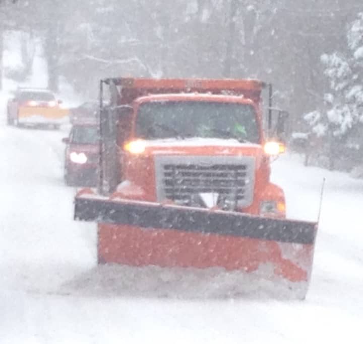 Snow plows from the Greenwich Department of Public Works hit the roads on Saturday as more than a foot of snow piled up.