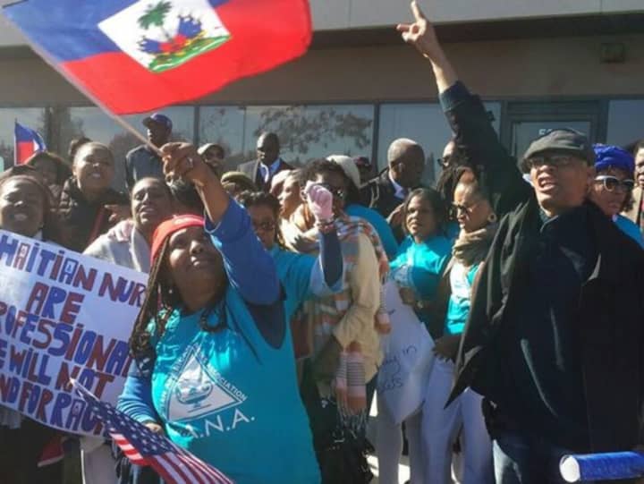 Dozens protest &quot;no haitians&quot; ad