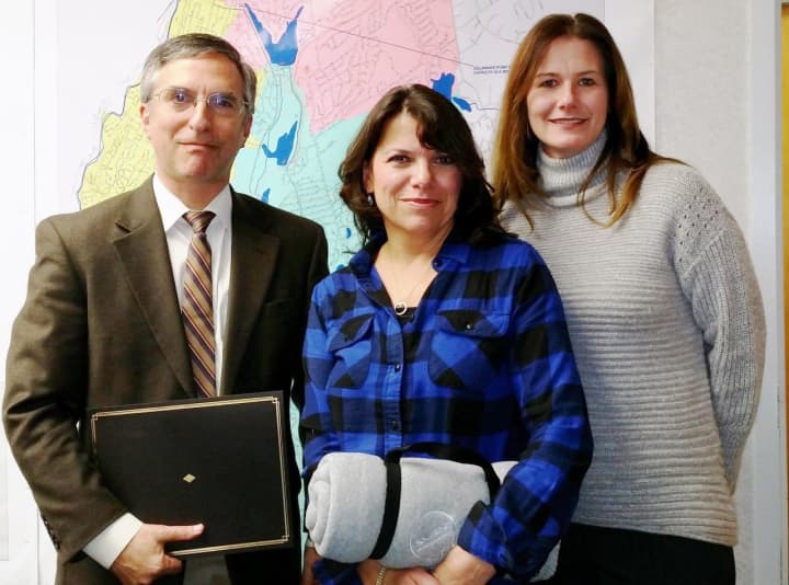 Bruce Reidenberg, M.D., of Rye, left, and Camille Taglia, of Eastchester, center, were recognized for their service by Lynda DiMenna, manager of SUEZ operations in Westchester County.