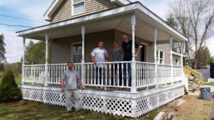 Members of the Newtown Police Department assisted in refurbishing the home of a disabled veteran.