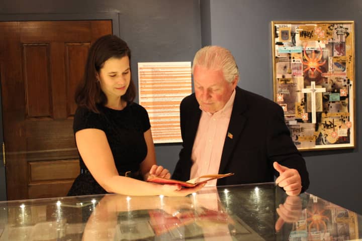 Heather-Marie Montilla, left, executive director of Pequot Library, shows Fairfield First Selectman Mike Tetreau Pequot&#x27;s 522-year-old &quot;Columbus Letter.&quot;