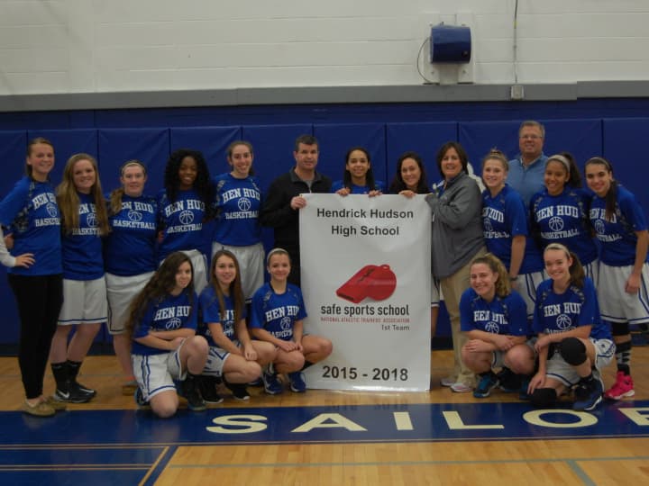 Members of the Hendrick Hudson Varsity Girls basketball team with Athletic Director Thomas Baker, Athletic Trainer Meg Greiner, and coaches Ken Sherman and Meghan Boyle celebrate the school’s designation as a Safe Sports School by NATA.