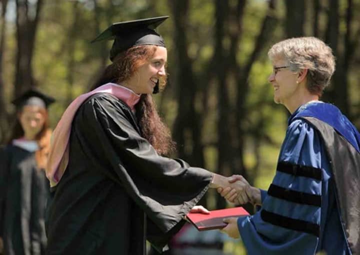 Vassar President Catharine Bond Hill presents a diploma at the Poughkeepsie college&#x27;s commencement exercises. She will be retiring at the end of the 2017 academic year.