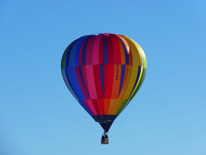 A volunteer at a hot air balloon event fell 15 feet from one of the balloons, receiving serious injuries.