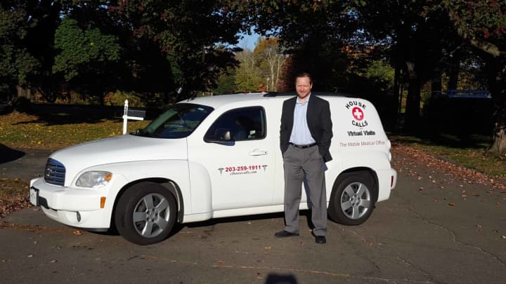 Lee Forest poses in front of his new mobile medical practice&#x27;s vehicle Friday morning.