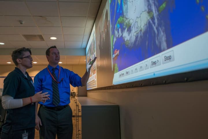 State officials look over a map of the path of Hurricane Joaquin last week. 