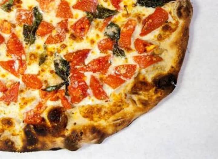 A slice of Frank Pepe&#x27;s famous &quot;fresh tomato pie.&quot;