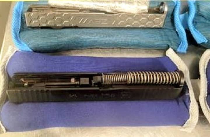 Gun parts hidden in wrist and ankle weights were found by TSA agents at Newark Airport.