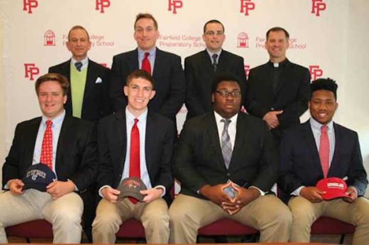 Front row, L-R: Aedan Ayer, Thomas Moore, Samuel Opont-Durogene and Calvin Reed. Second row, L-R: Principal Dr. Robert Perrotta, Coach Keith Hellstern, Asst. Athletic Director Jay Turiano and President Rev. Tom Simisky.
